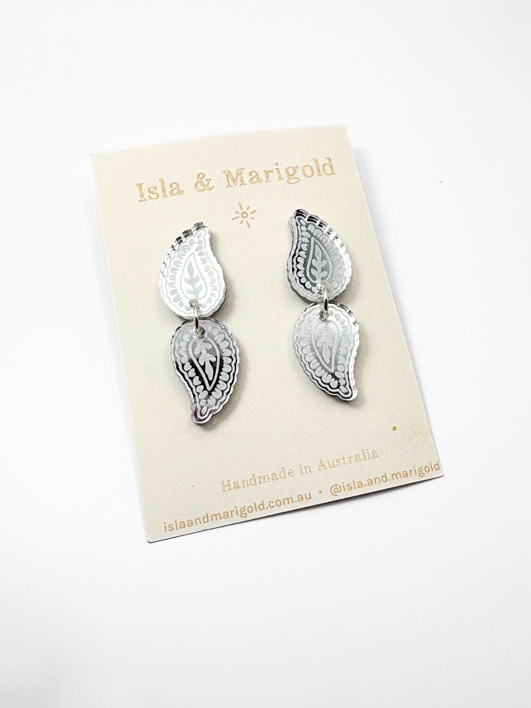 Silver earrings on a 'Isla & Marigold' branded card against a white background