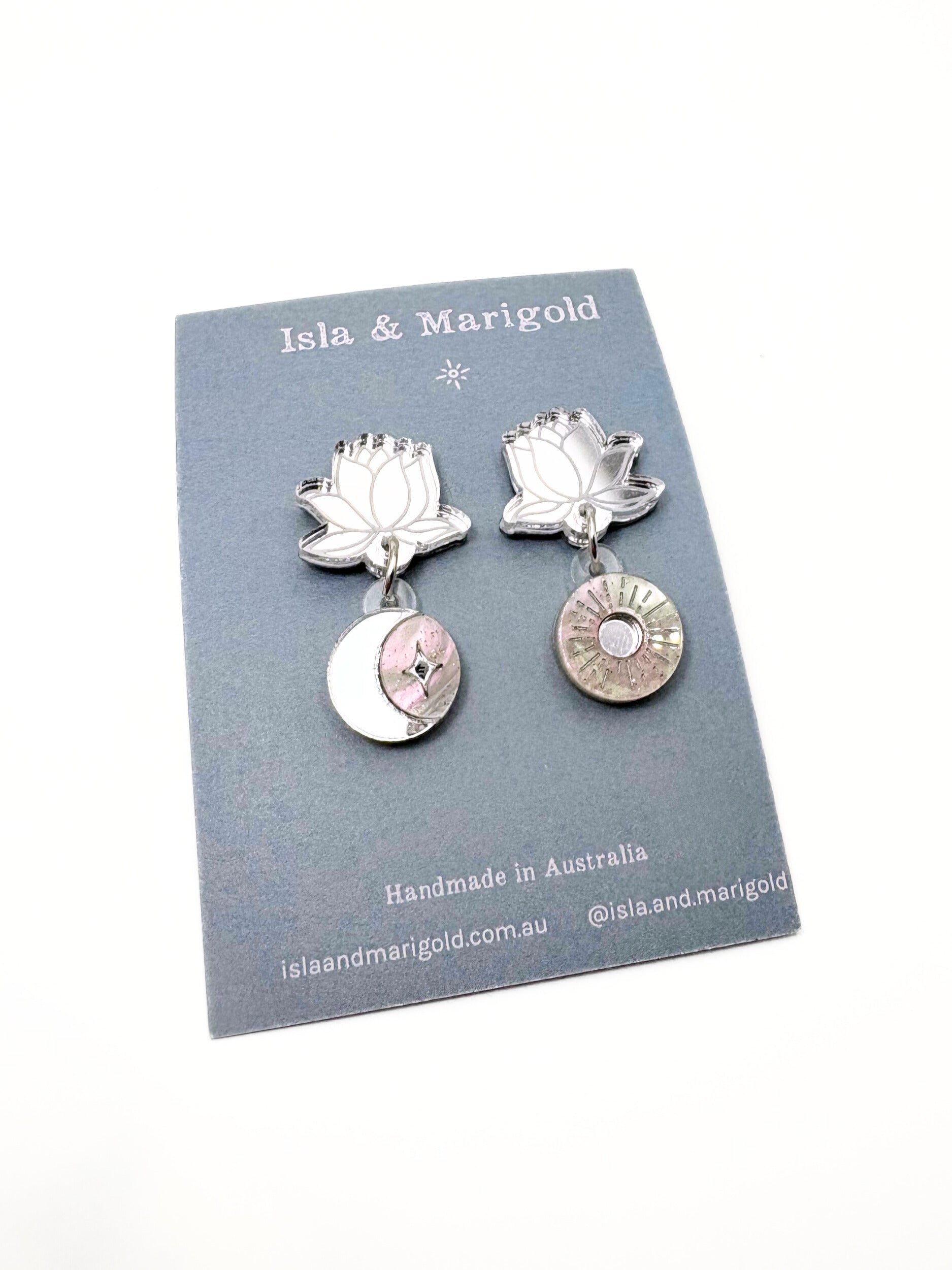 Silver lotus flower earrings on a branded card with 'Isla & Marigold' branding.
