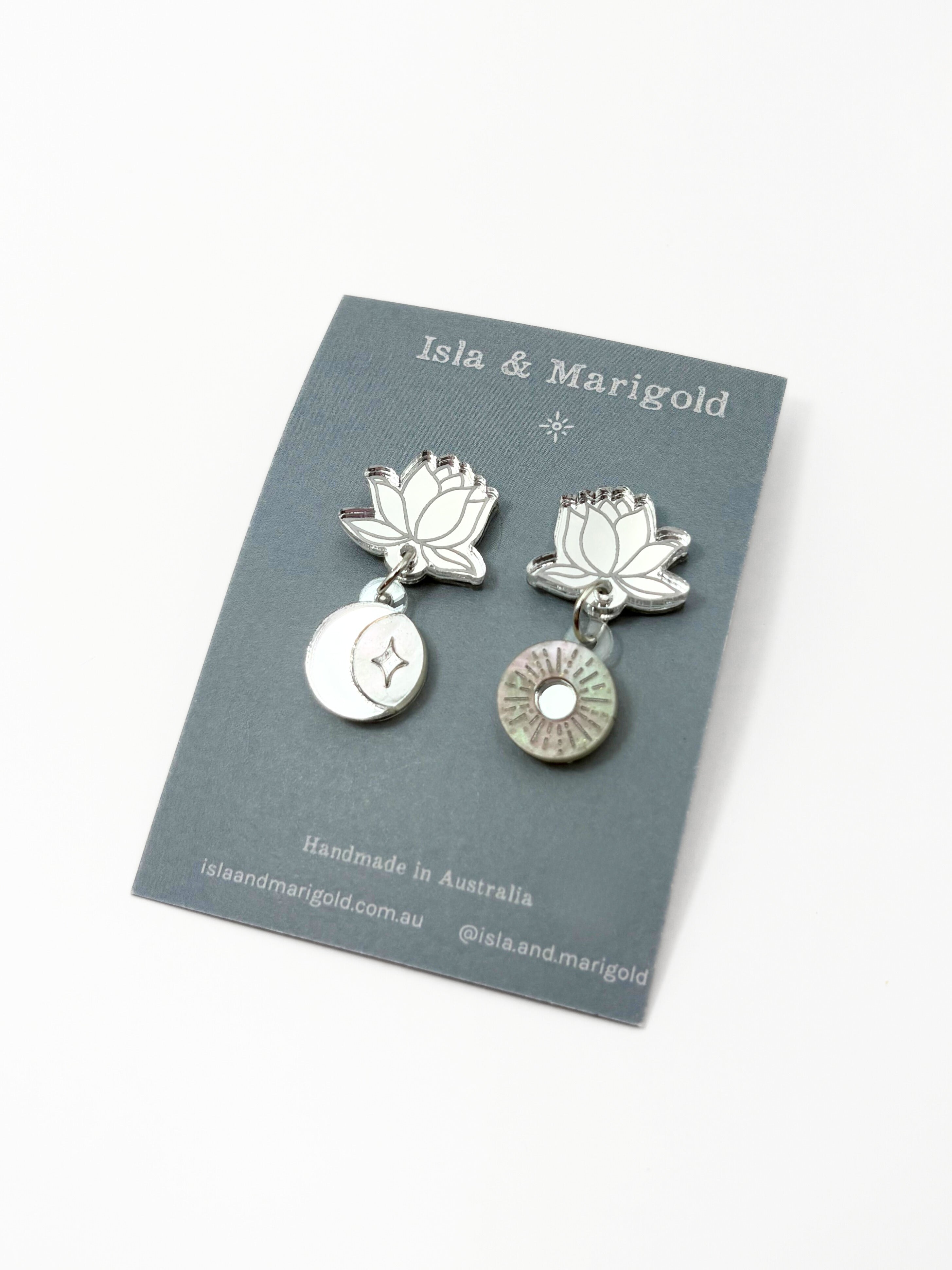 Silver lotus flower earrings on a branded card with 'Isla & Marigold' branding.
