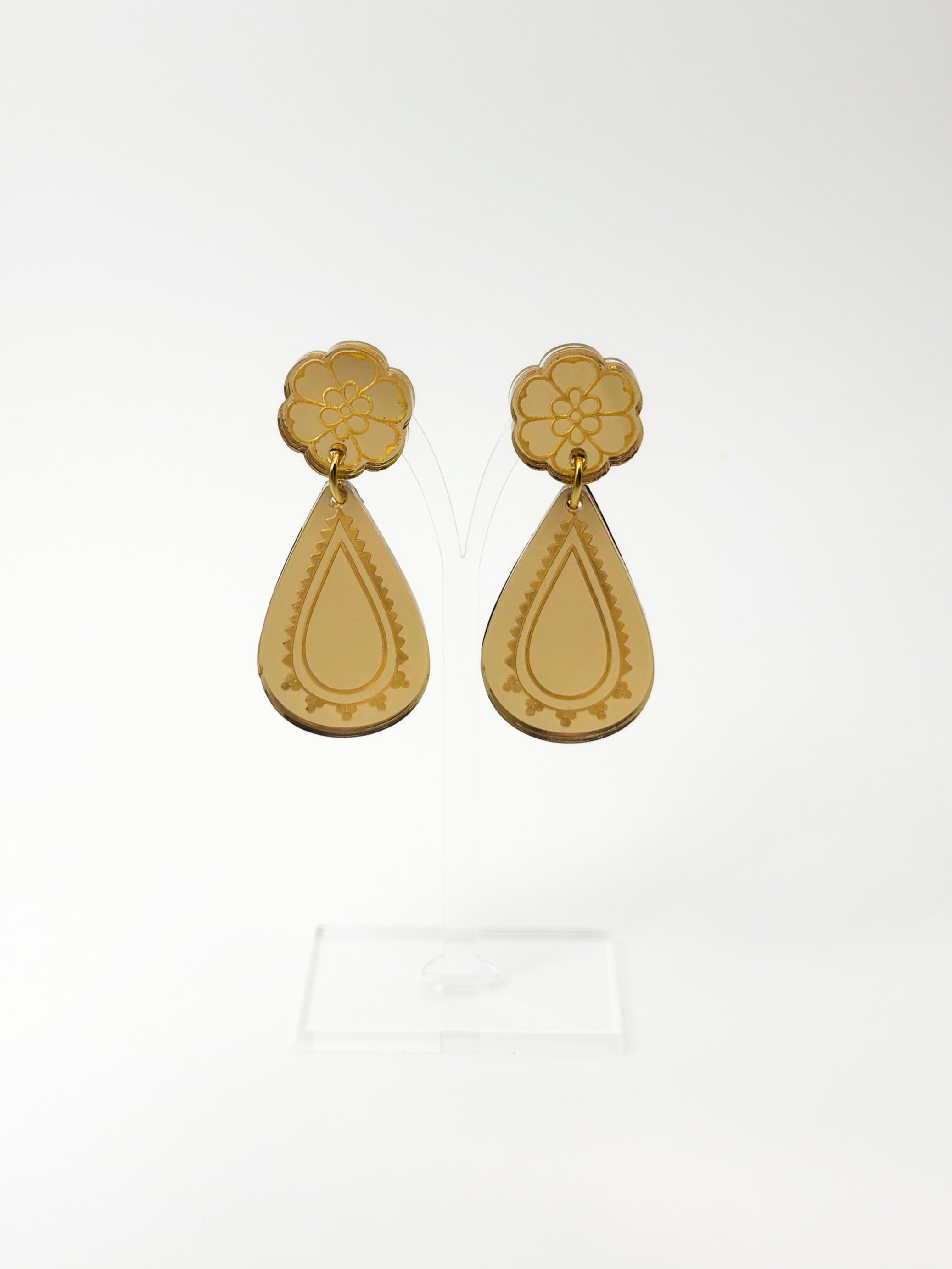 Pair of gold earrings on a white background