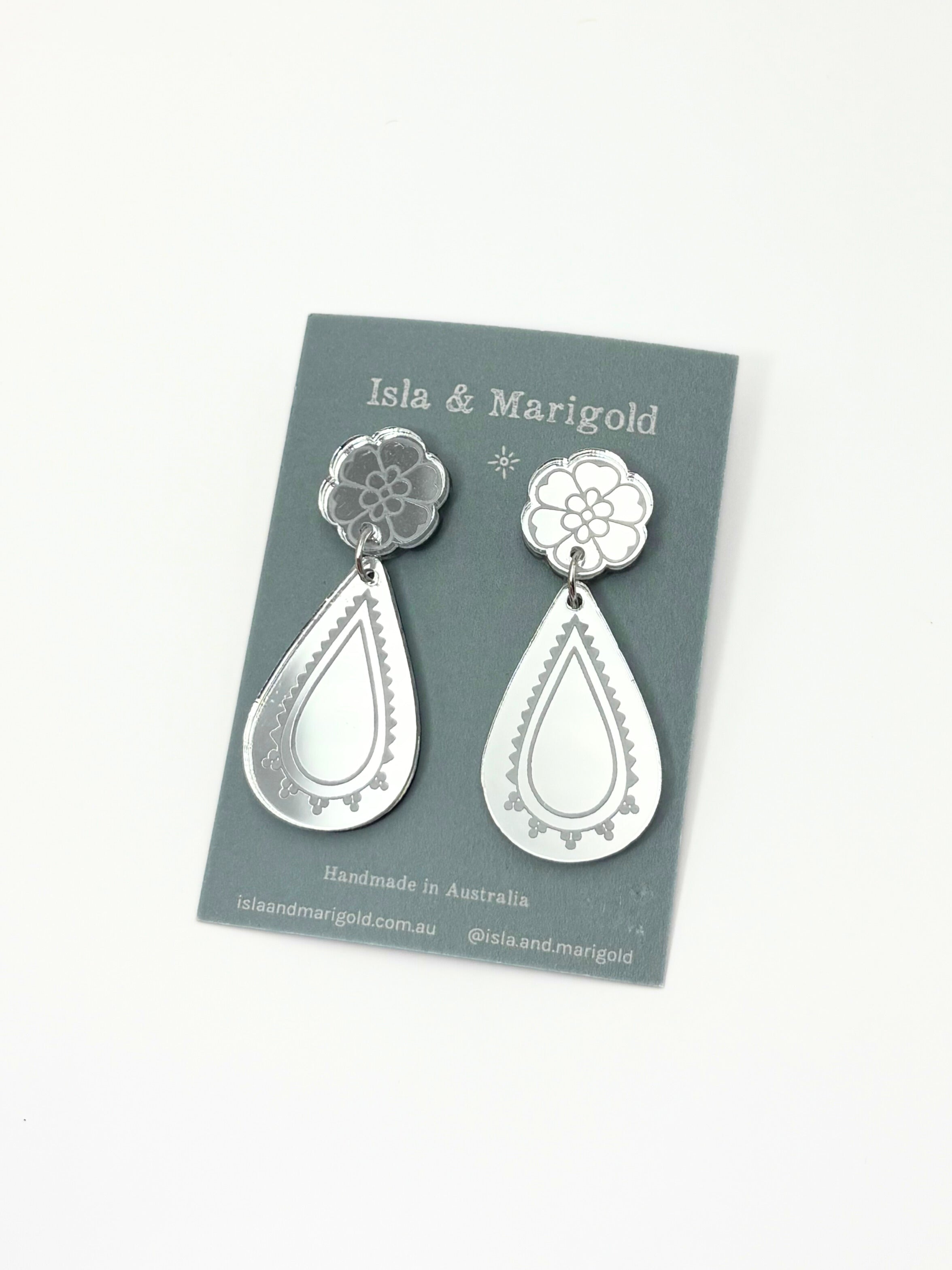 Silver teardrop earrings on a Isla & Marigold branded card against a white background