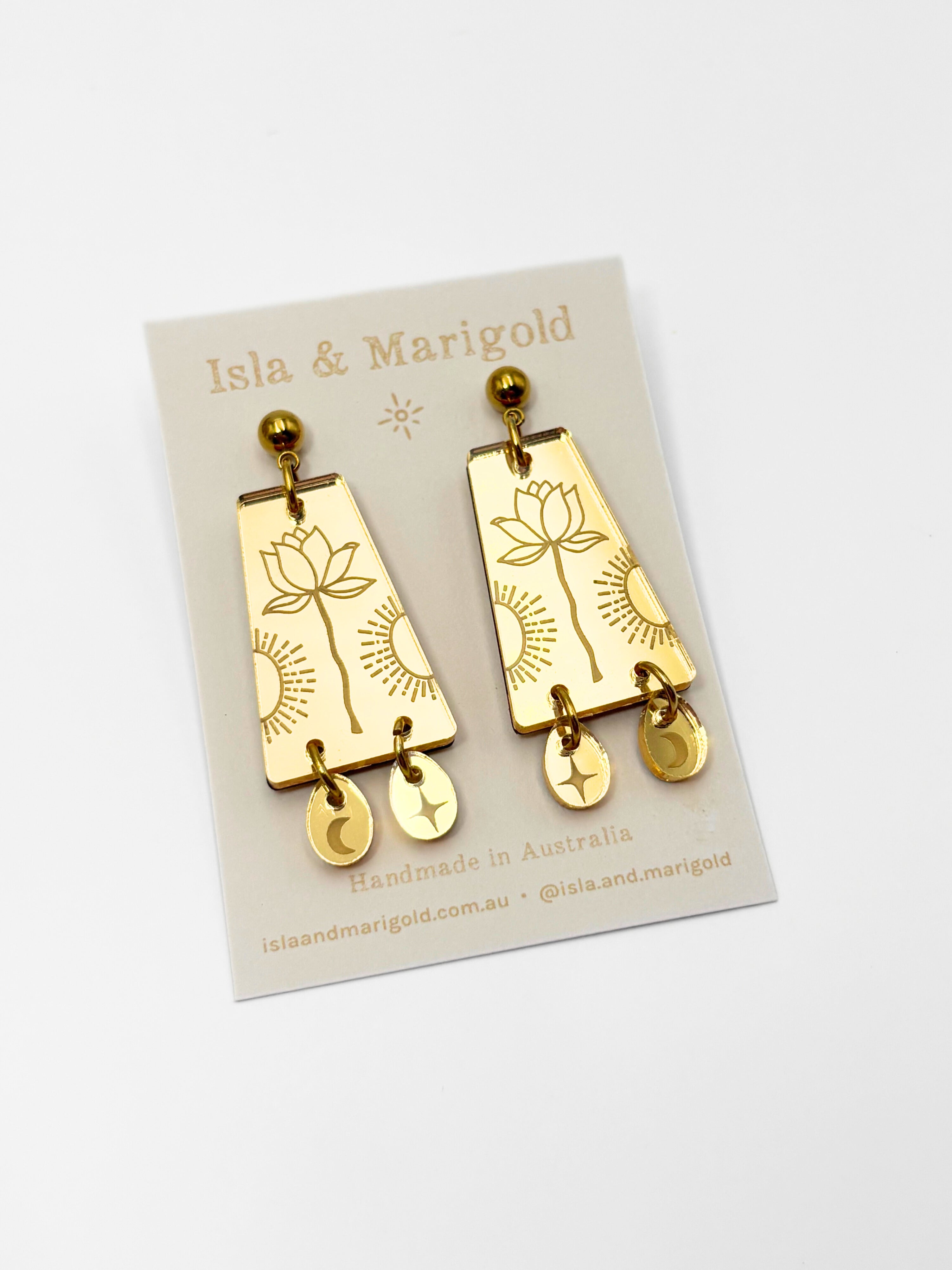 Gold earrings on a branded card with 'Isla & Marigold' branding.