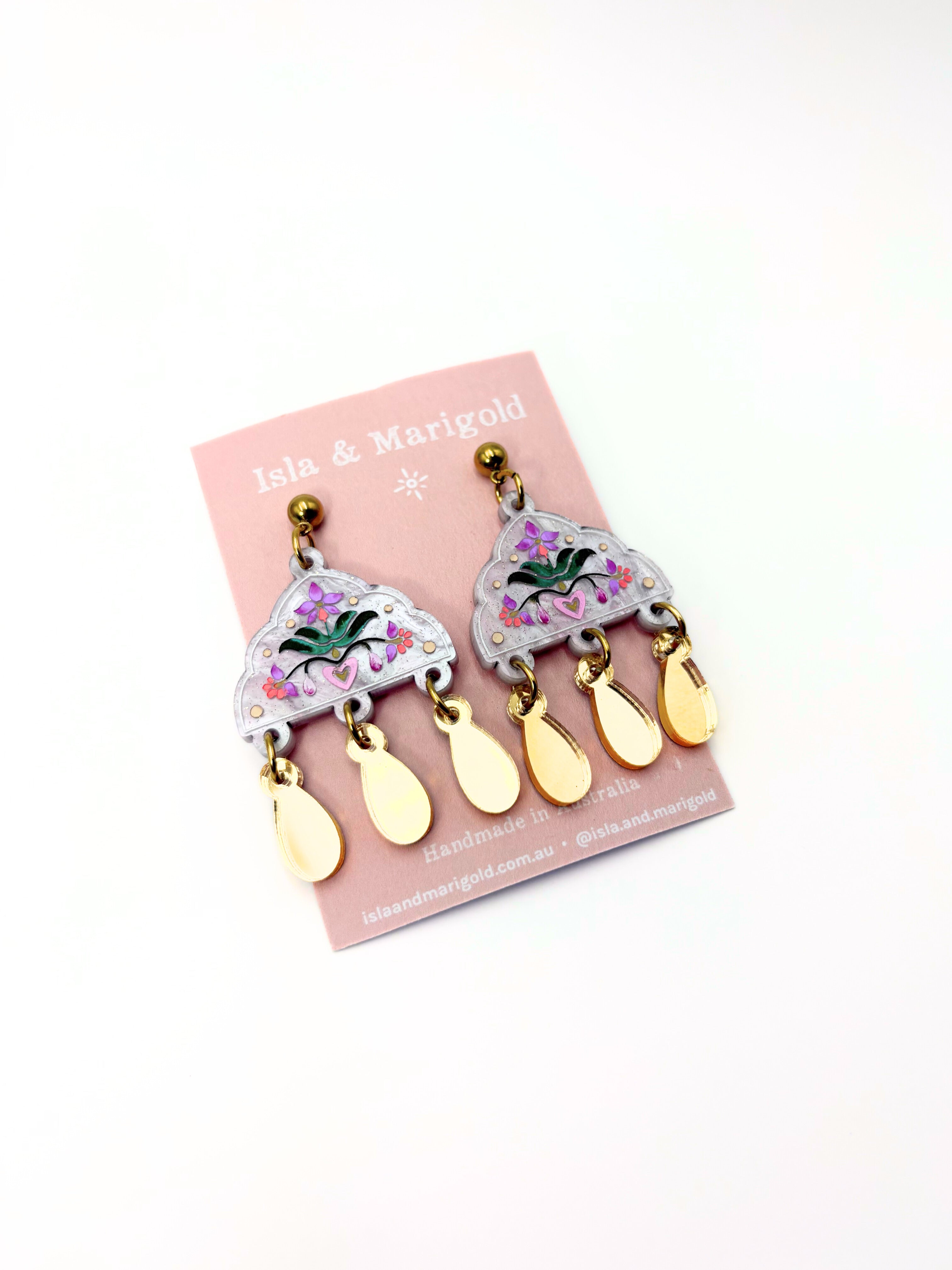 Pair of earrings on a Isla & Marigold branded card with a white background