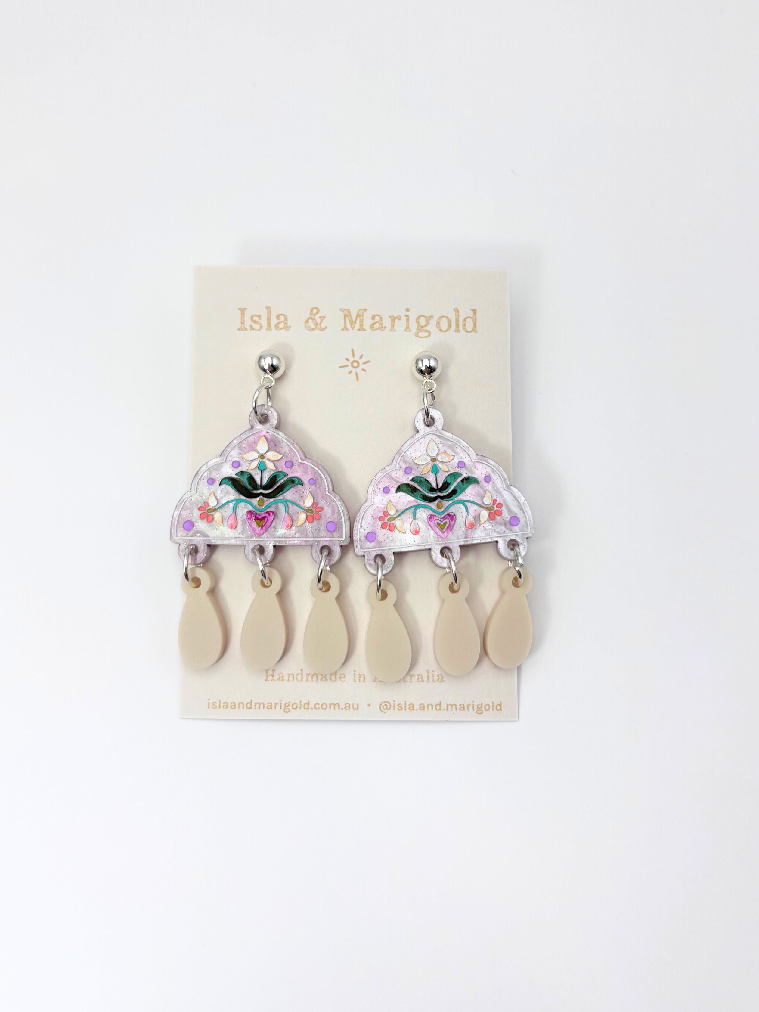 Pair of earrings on a 'Isla & Marigold' branded card against a white background