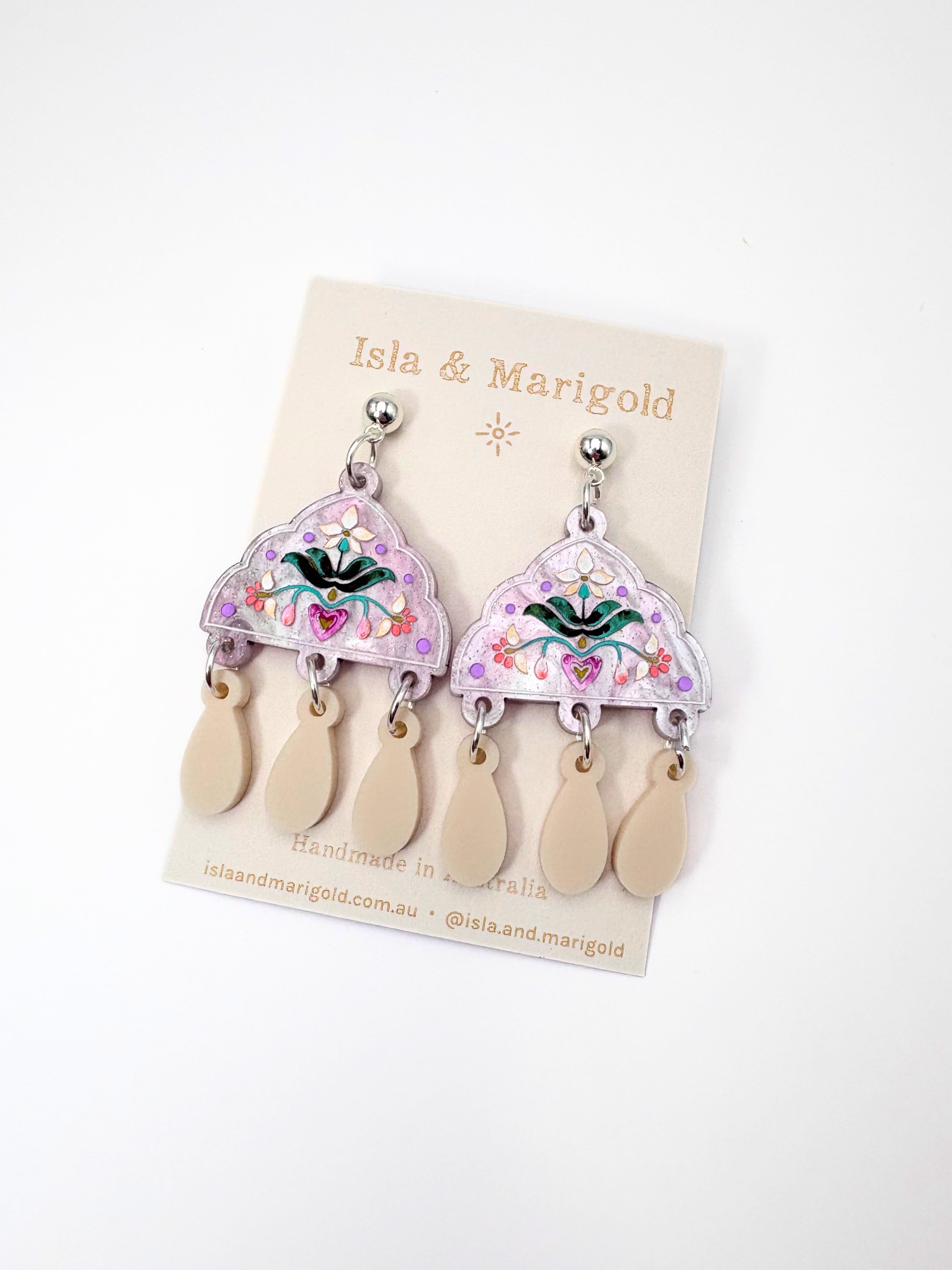 Pair of acrylic silver earrings on a 'Isla & Marigold' branded card against a white background