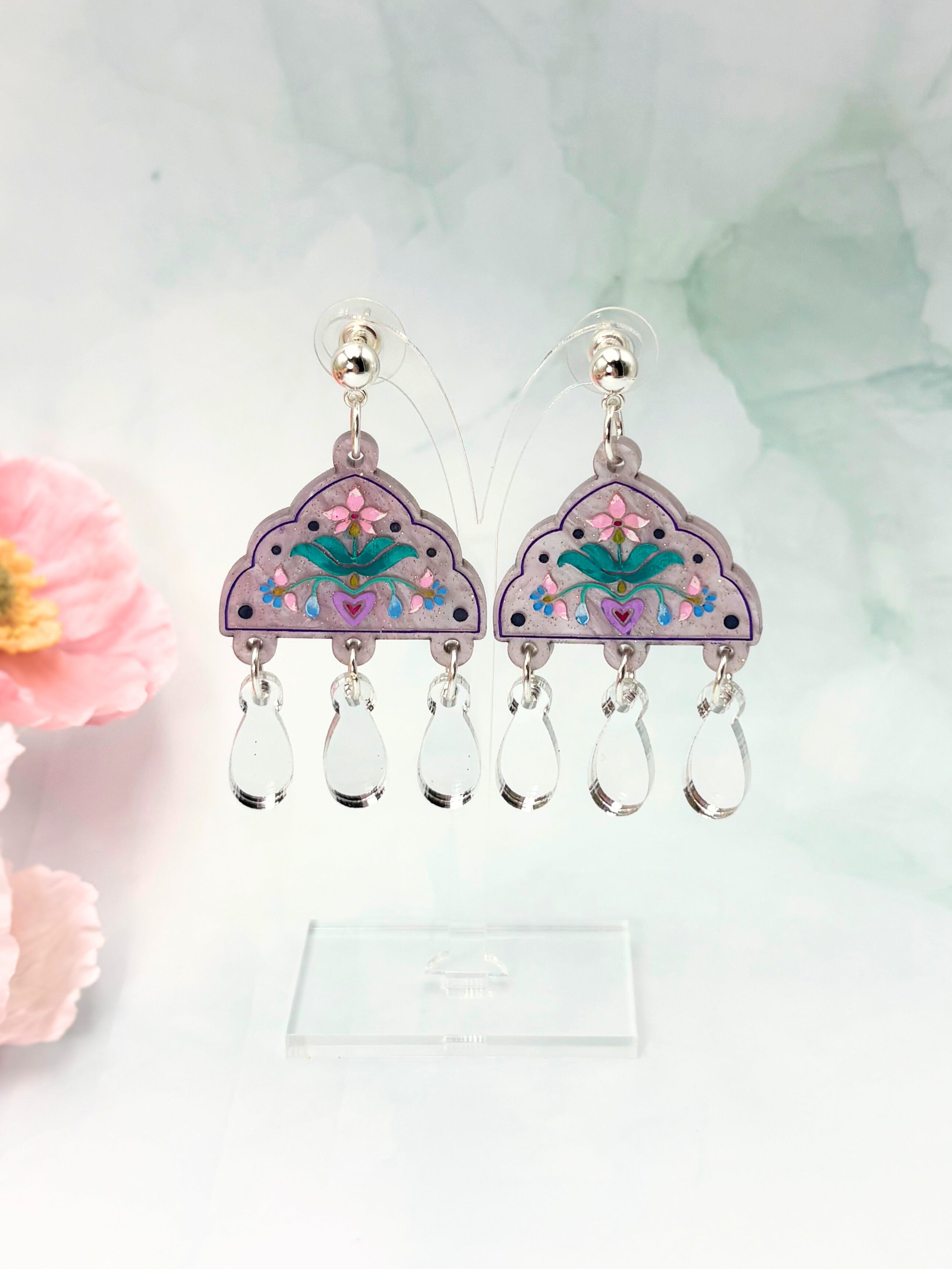 Decorative earrings with floral design on a light background