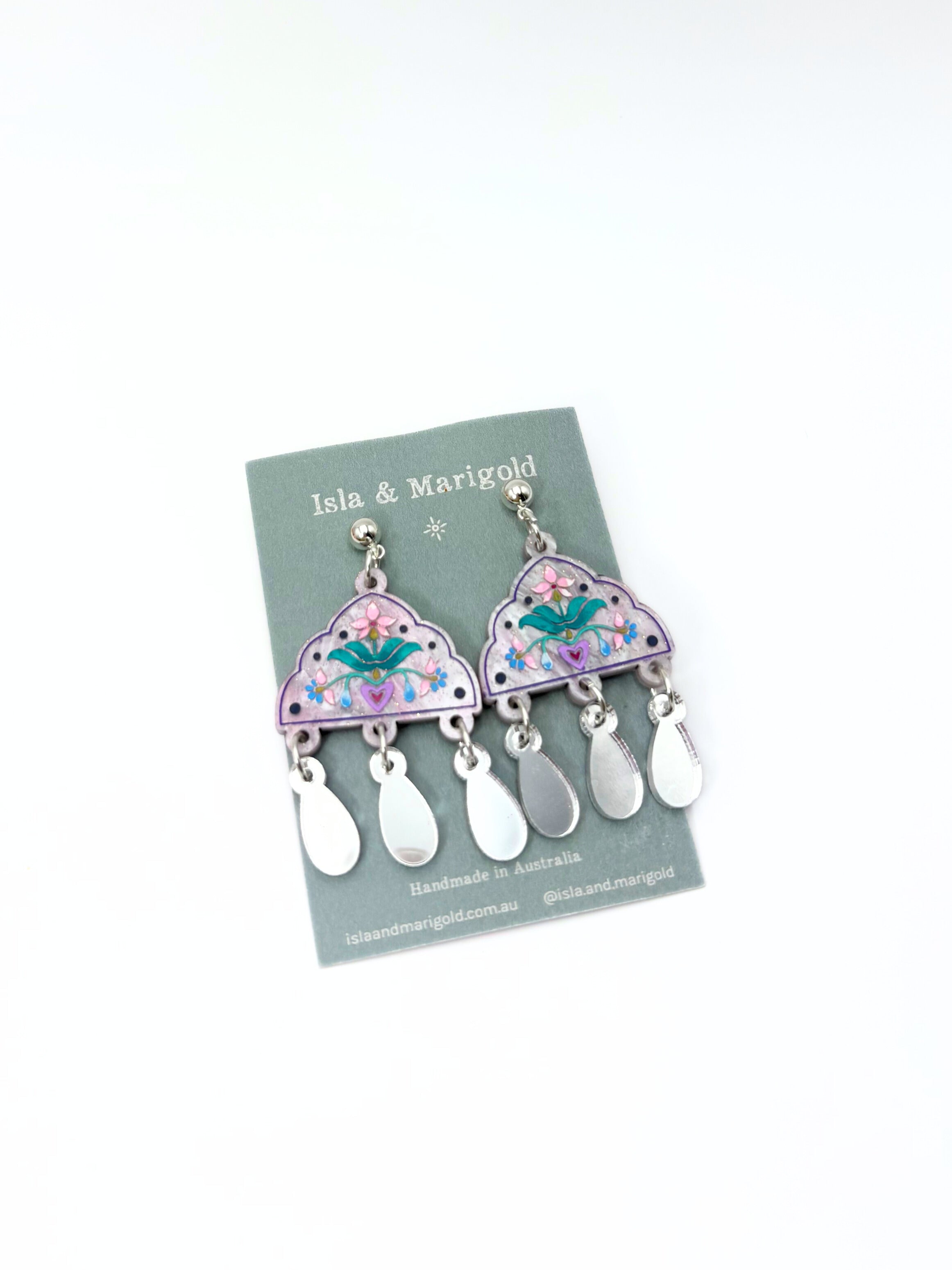 Pair of earrings on a branded card with a white background