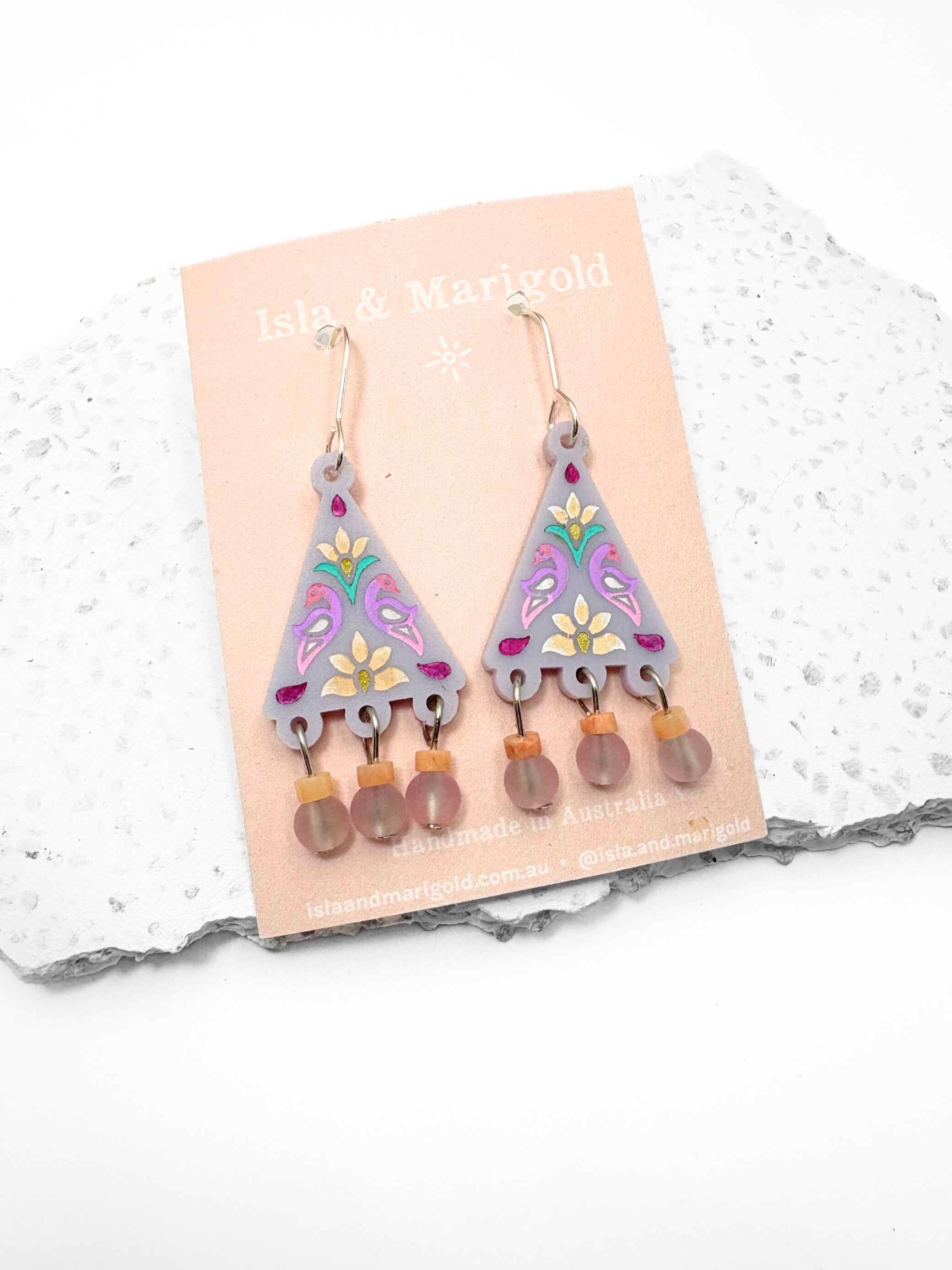 Pair of earrings on a display card with a white background