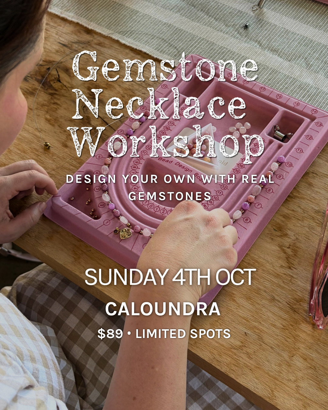 Promotional graphic for a Gemstone Necklace Workshop, showing a person's hands and partial head working with beads on a pink tray at a wooden table. Large white text reads 'Gemstone Necklace Workshop' with event details 'Sunday 4th Oct Caloundra $89 • Limited Spots'.