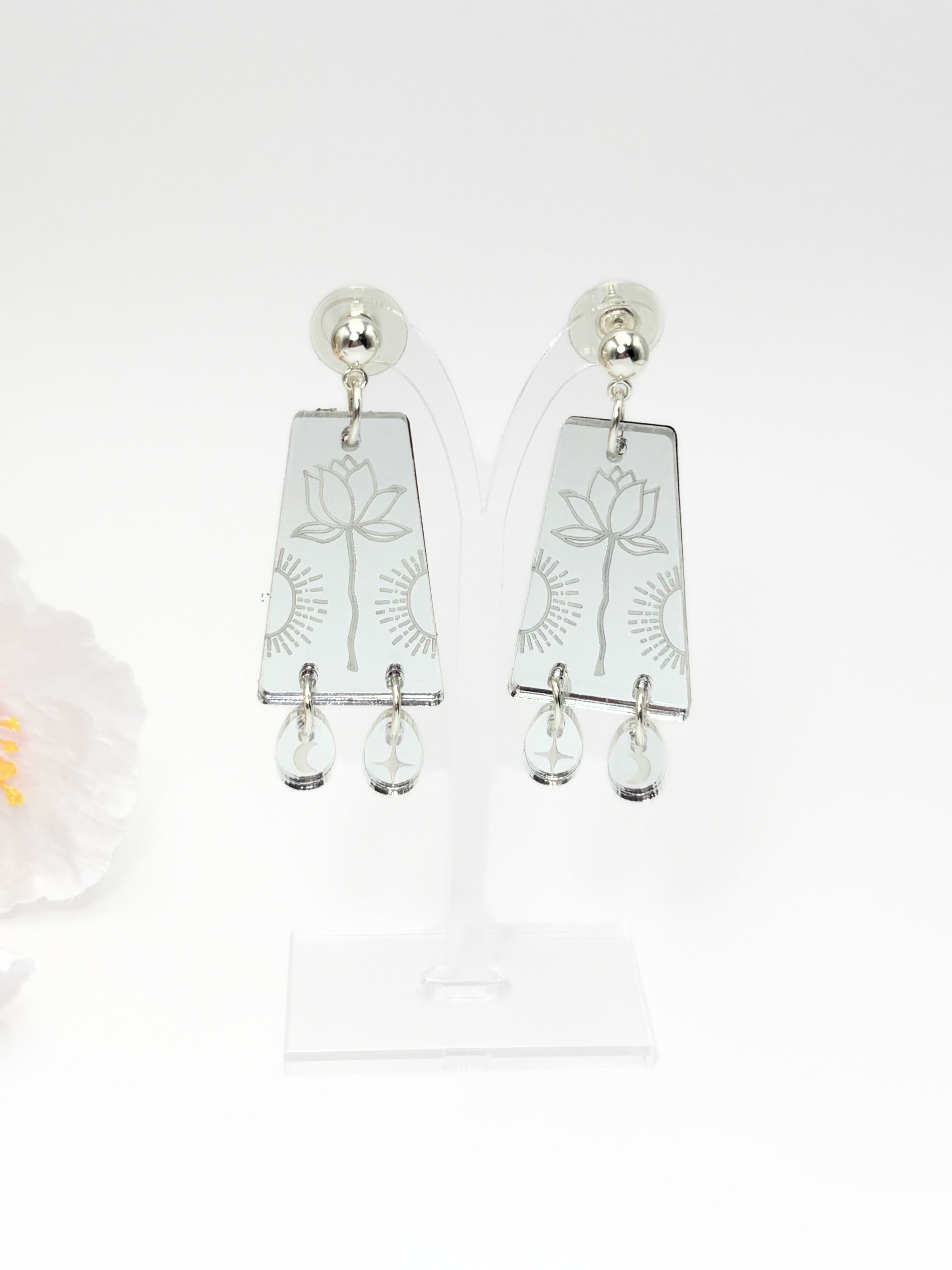 Pair of earrings with floral design on a white background