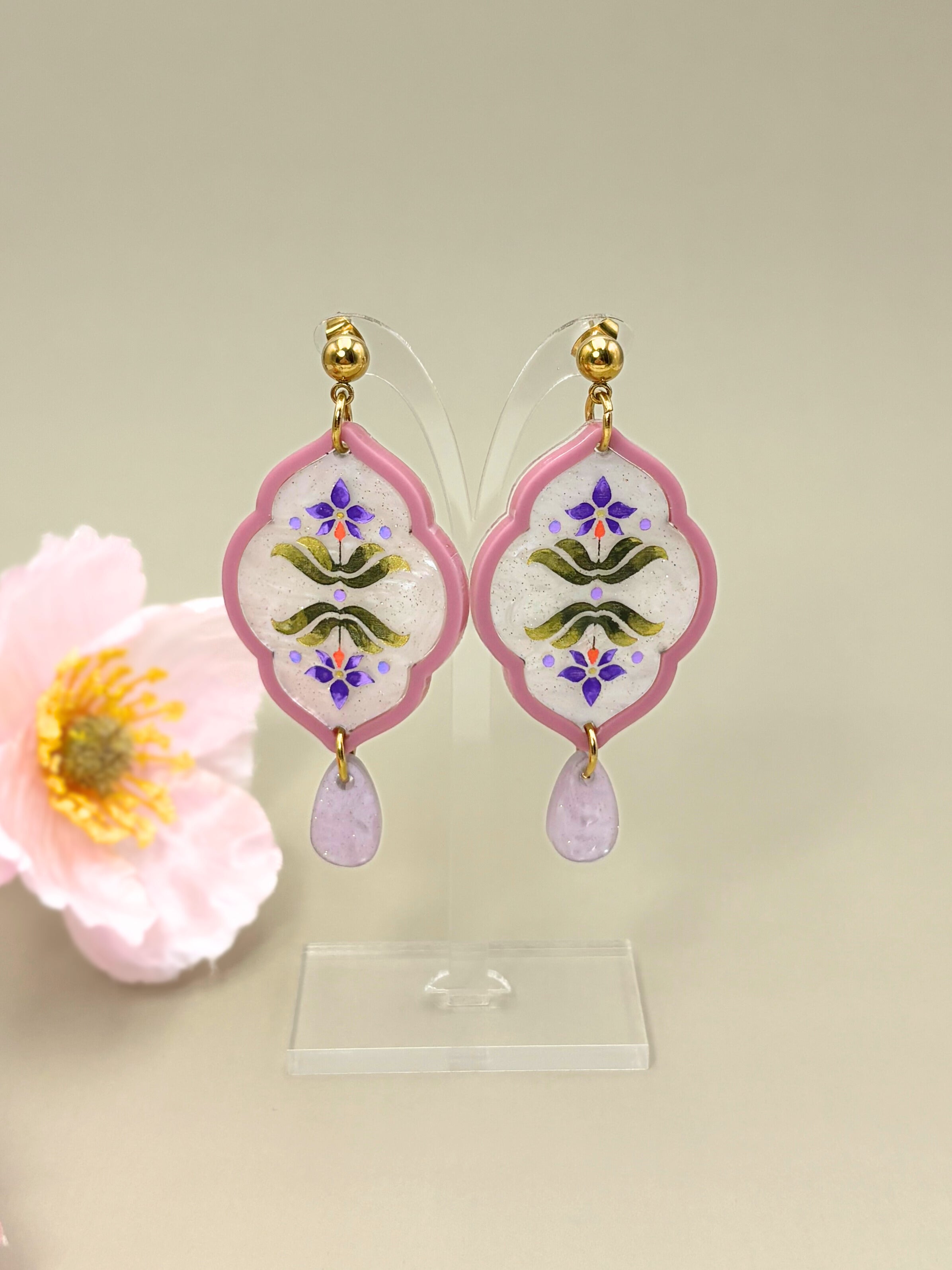 Decorative earrings with floral design on a light background