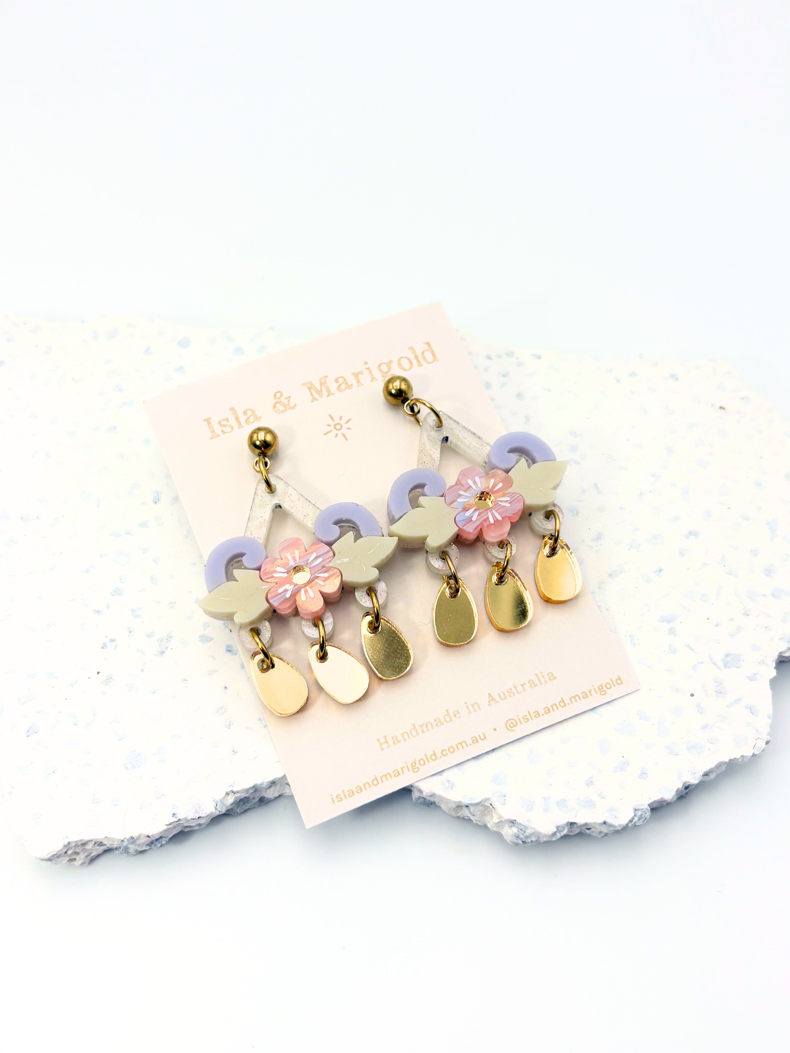 Colorful earrings on a white card with a white background